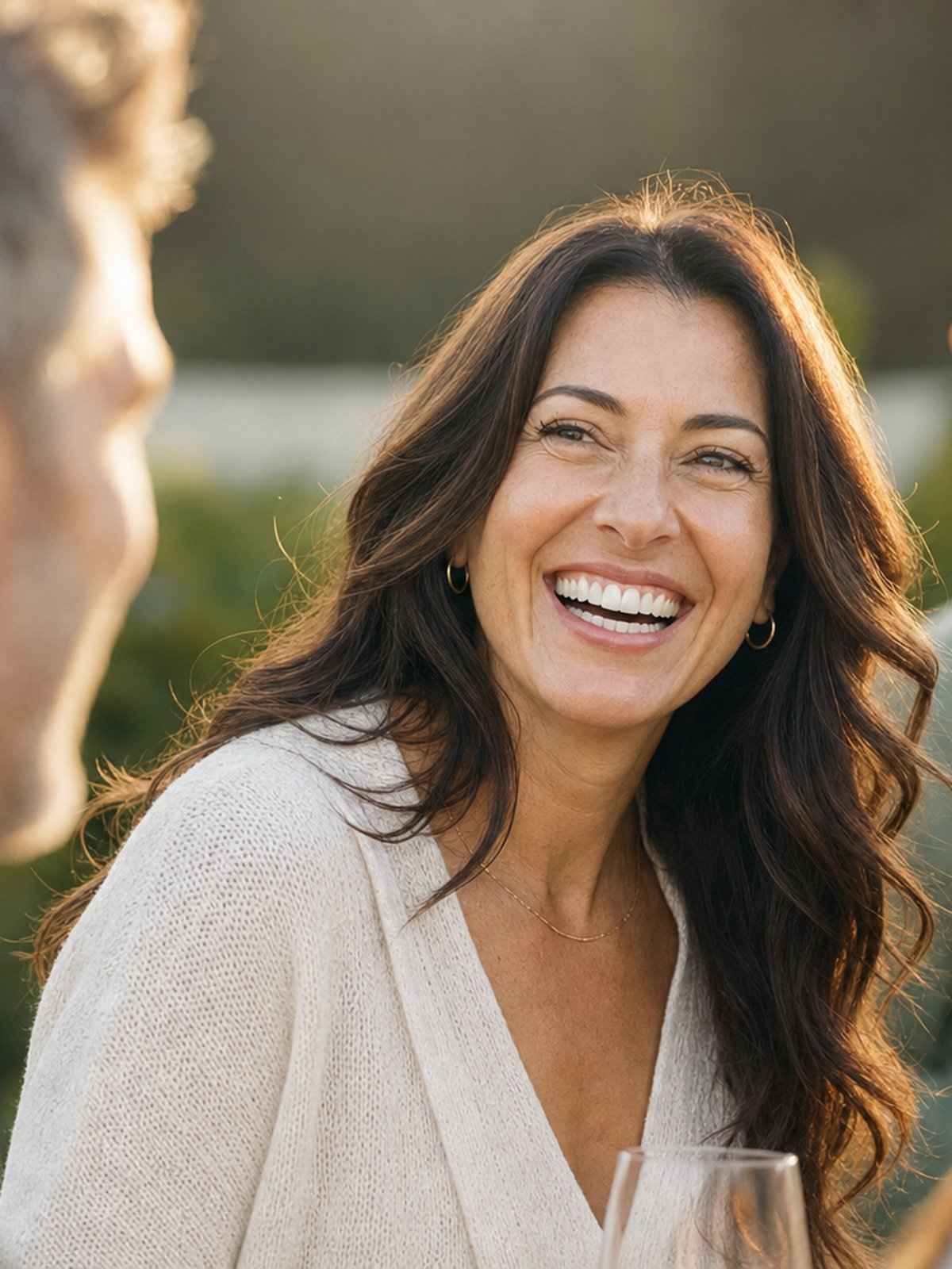 A woman laughing with friends